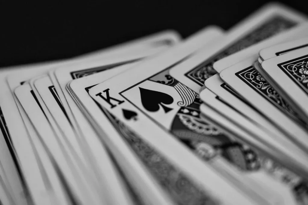 Black-and-white playing cards spread on a dark surface